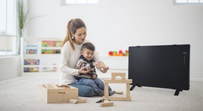 Mother and child at play, with a Rinnai panel heater nearby