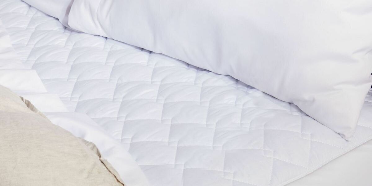 A Sunbeam brand quilted electric blanket on a bed
